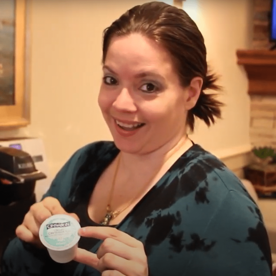 cary Family Dental Team Member holding coffee pod smiling