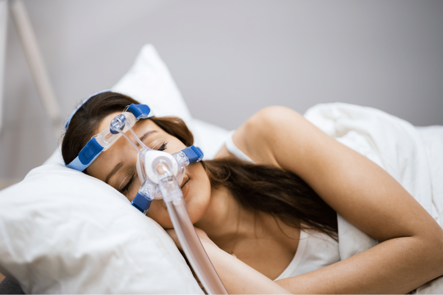 Woman wearing Sleep apnea face mask