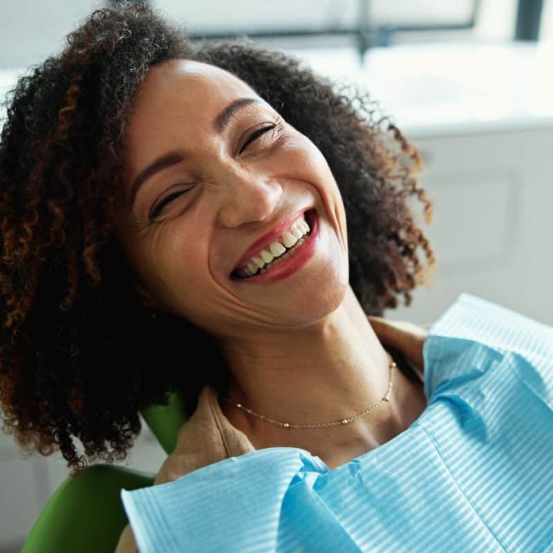 smiling woman sitting in a dental chair. routine checkup